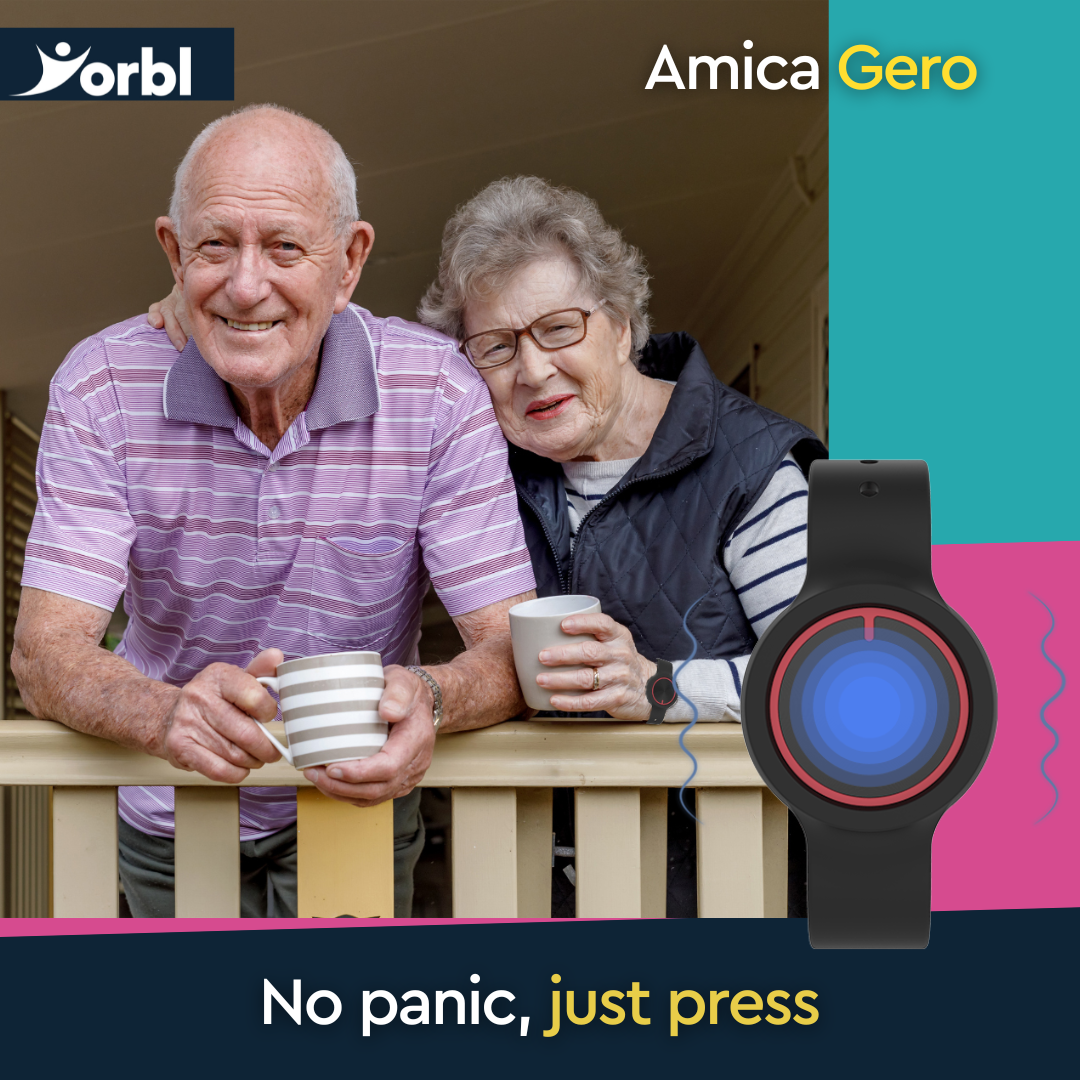 A senior man and woman drink tea over the side of a balcony, the lady is wearing a Yorbl Amica Gero personal alarm.