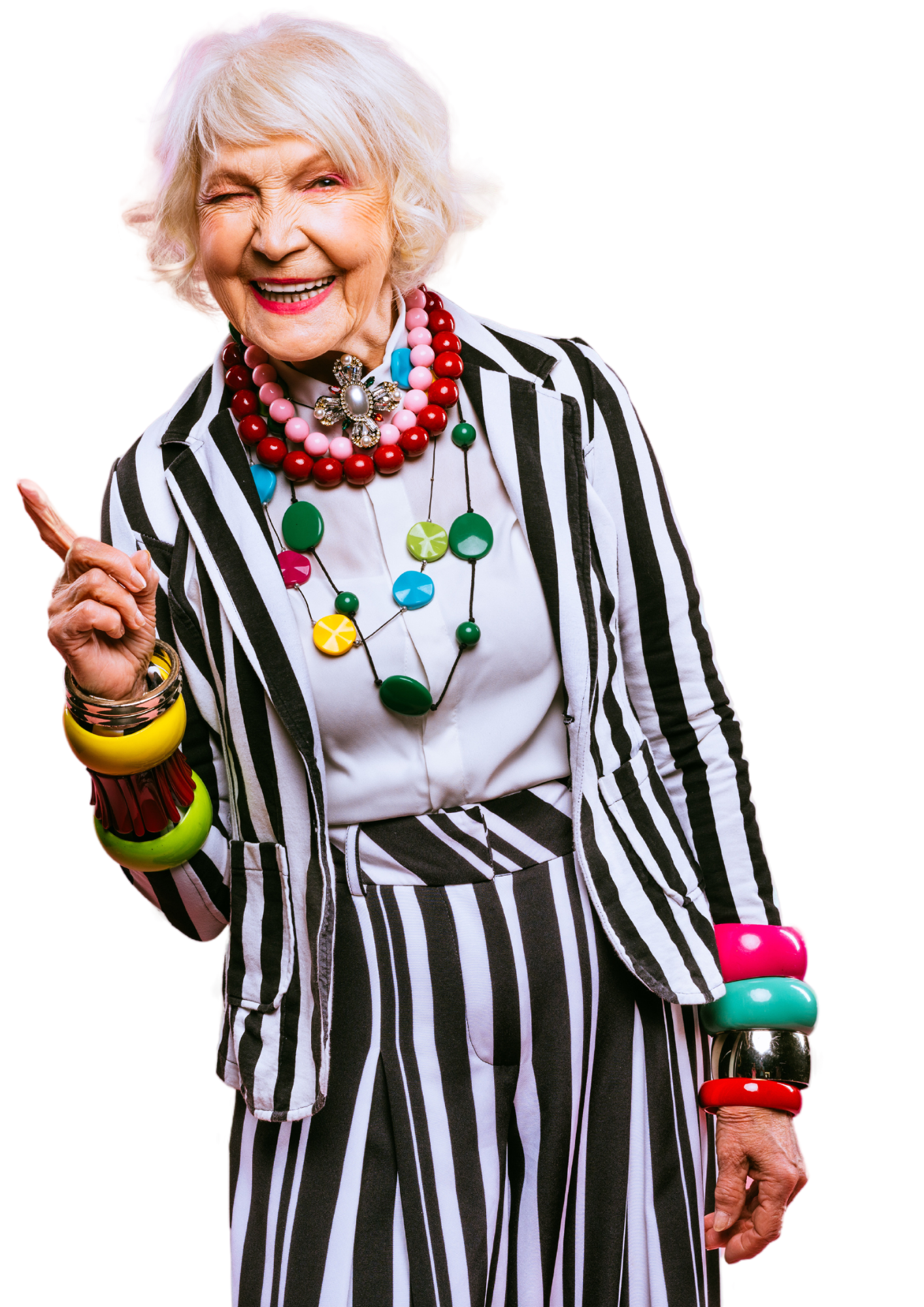 Senior lady with striped suit on and colourful necklace pointing upwards