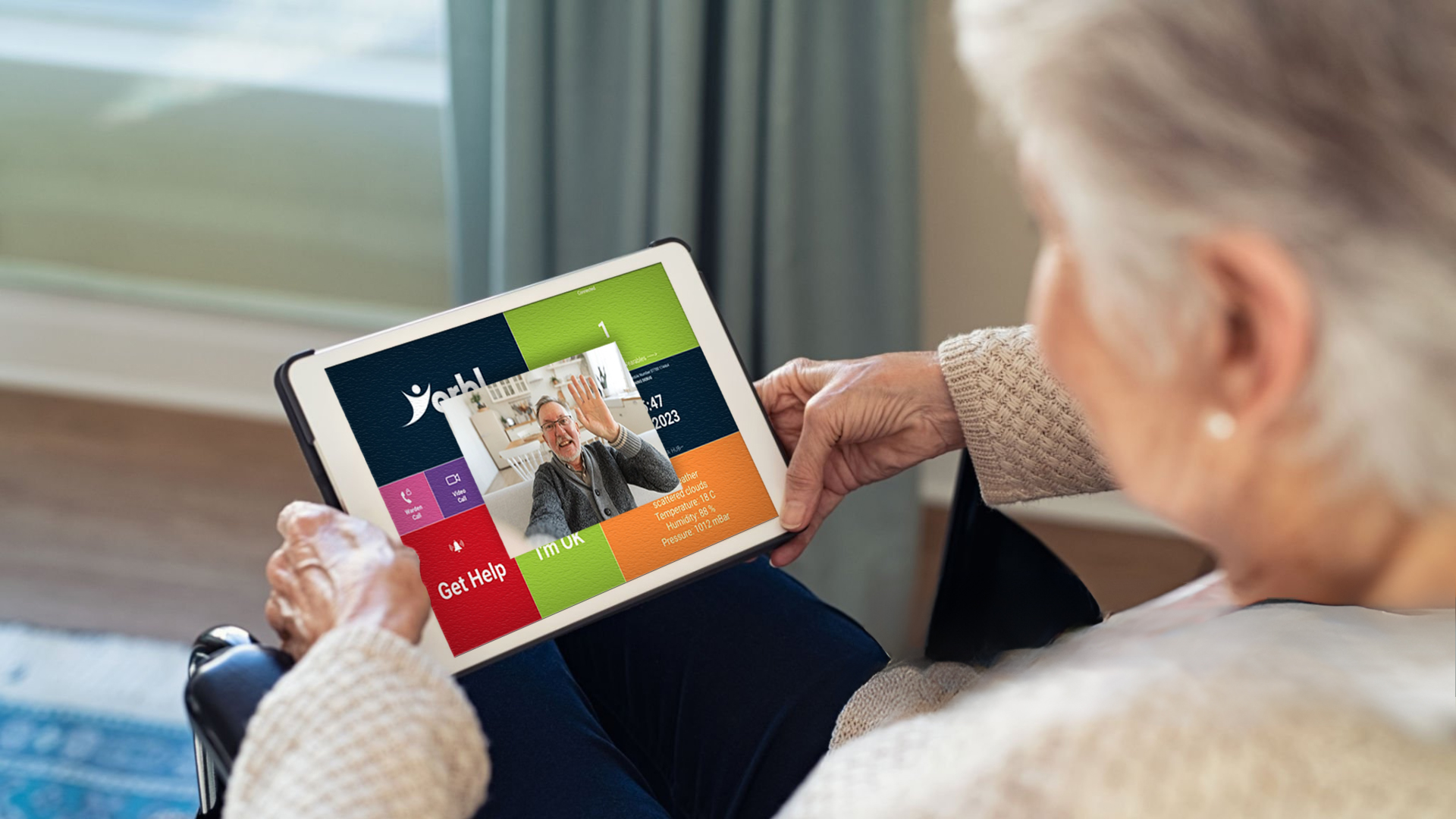 Senior woman holding a tablet talking to friend via video calling